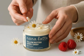 Close-up of Nana Latta Tallow Butter Family Daisy with chamomile and raspberry, being scooped from a glass jar.