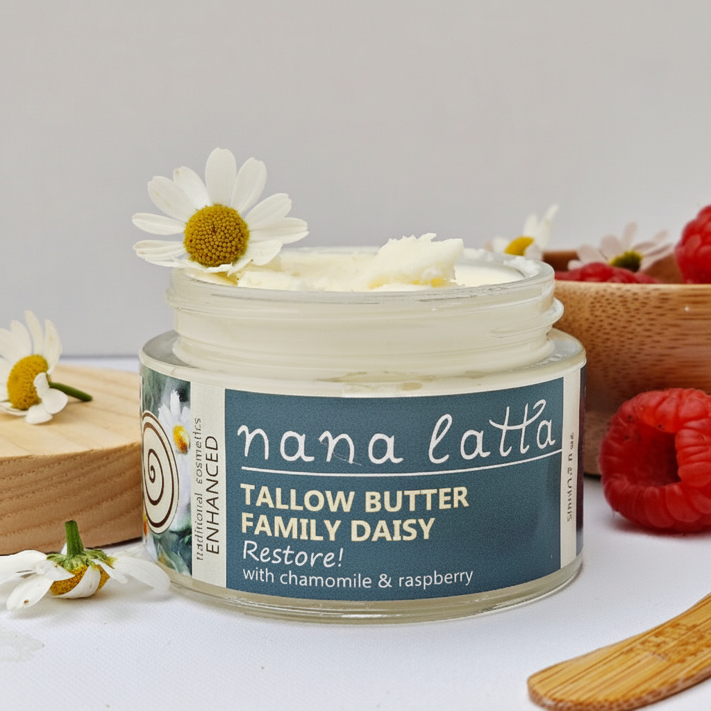 Jar of tallow butter with a daisy on top, surrounded by flowers and raspberries.